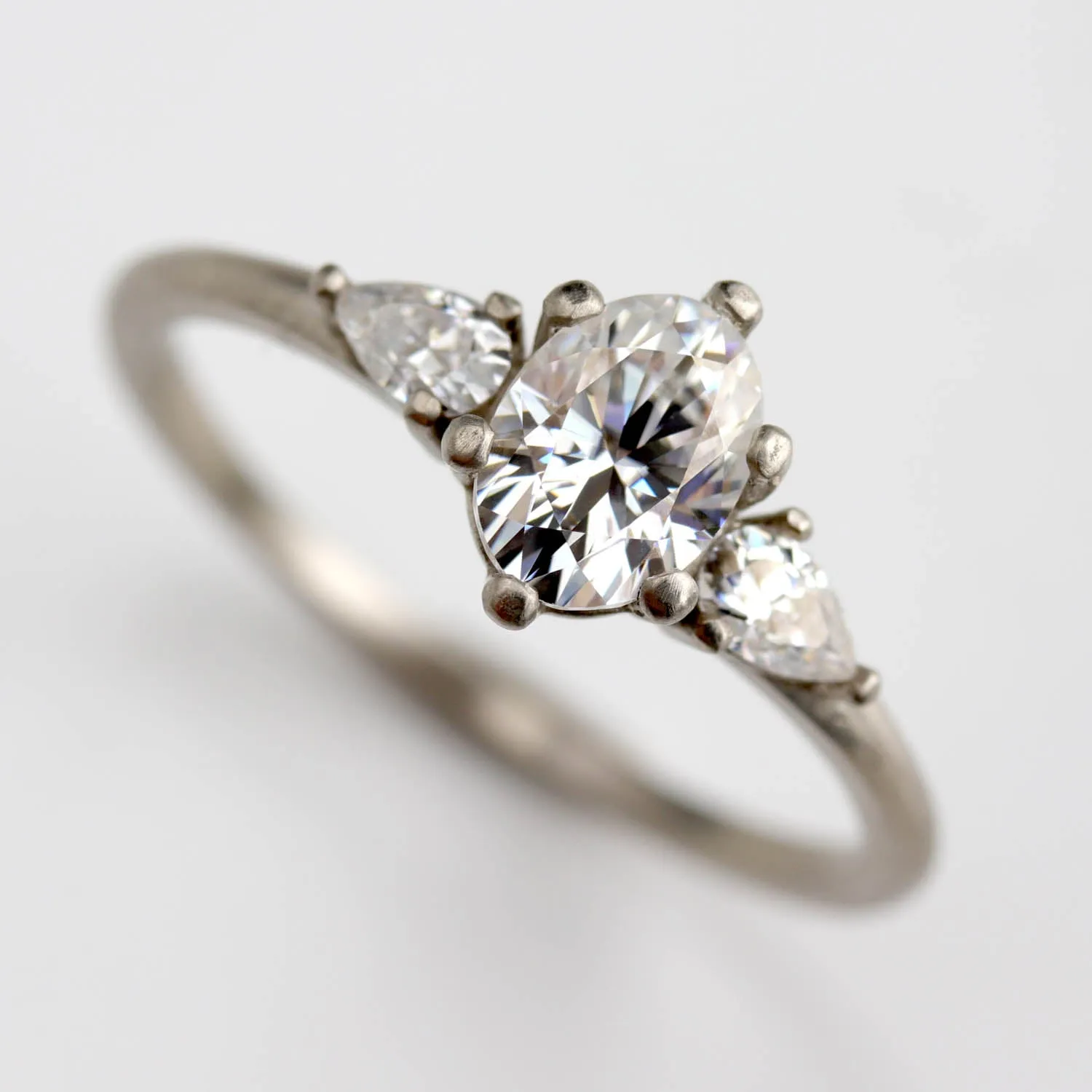 Prong-set Oval Three Stone Ring with Pear-shaped Side Stones